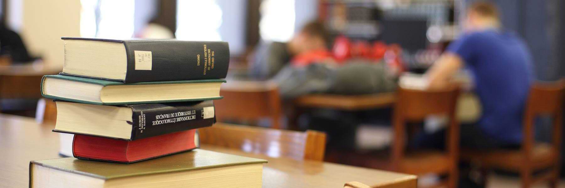 A stack of books on a table.